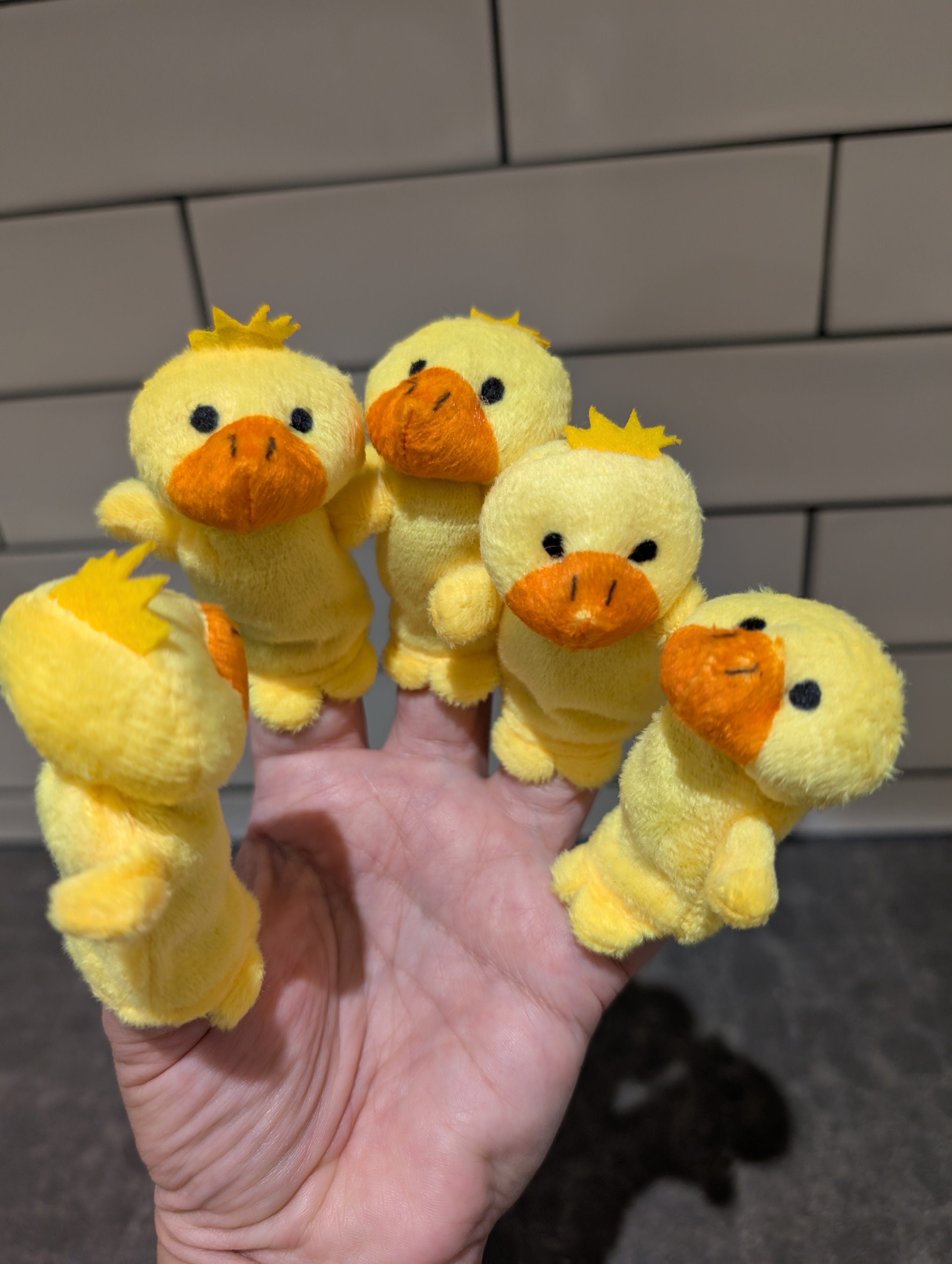 Five yellow duck finger puppets in use/on hand